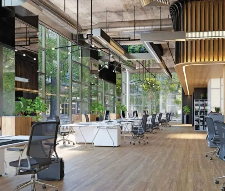 Spacious office interior with large windows, wooden flooring, and contemporary furniture design.