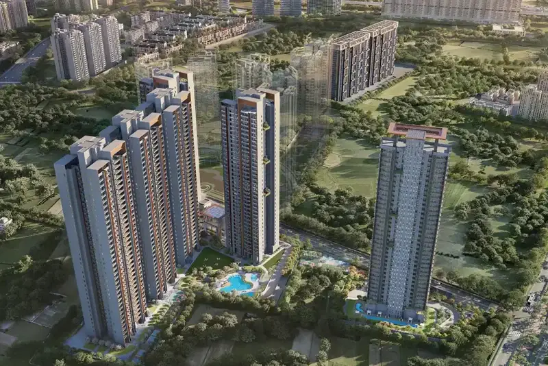 Aerial view of modern residential towers surrounded by greenery and swimming pools.