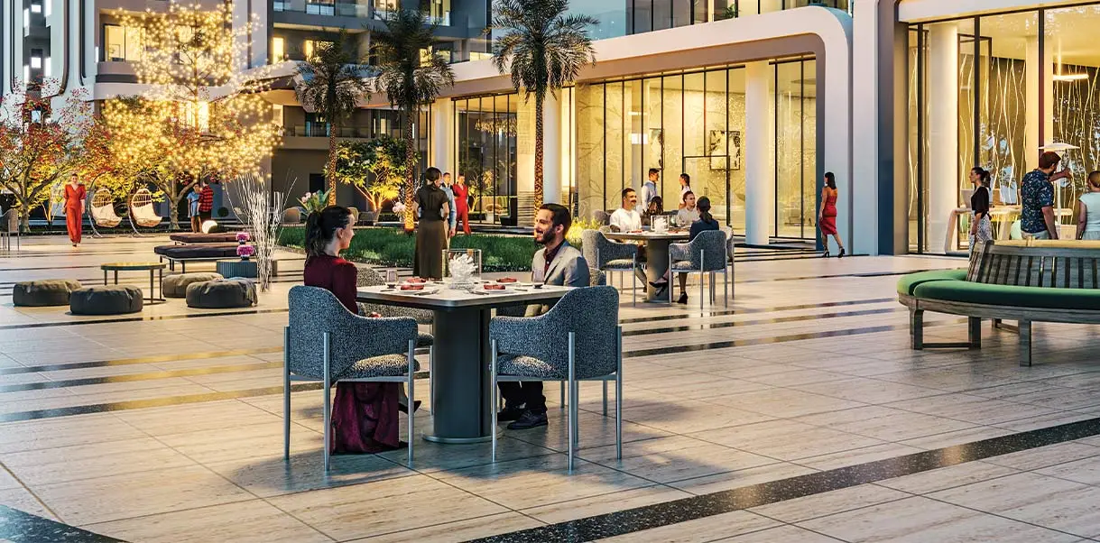 Couple dining at a table in a modern outdoor setting with palm trees and decorative lights.