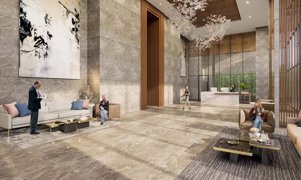 Modern lobby with marble flooring, seating areas, artwork, and a reception desk.
