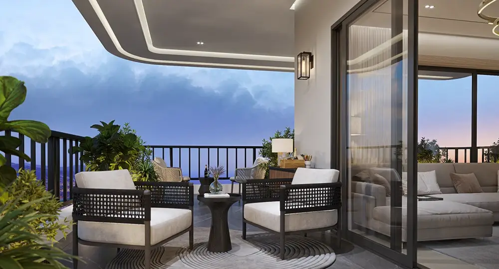 Stylish balcony with two chairs, a round table, plants, and a view of the sky.