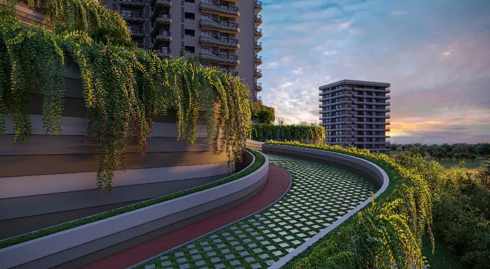 Curved jogging track surrounded by greenery and modern buildings at sunset.