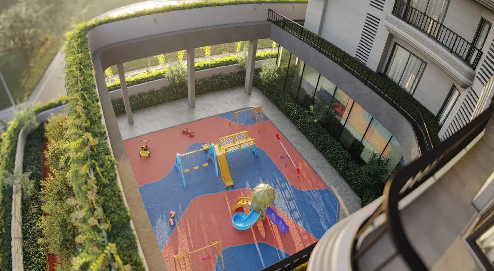 A colorful kids play area with slides, swings, and play equipment surrounded by greenery.