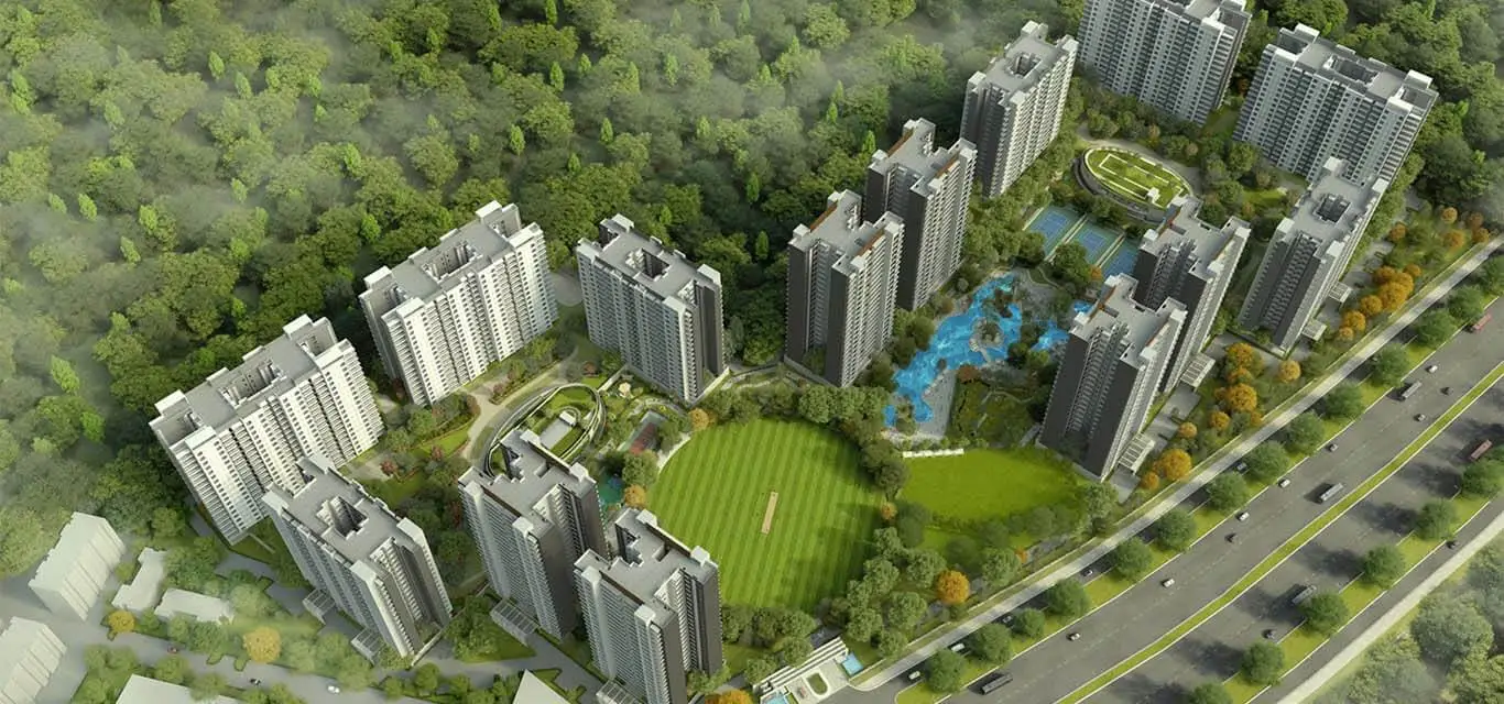 Aerial view of residential buildings surrounded by greenery, parks, and water features.