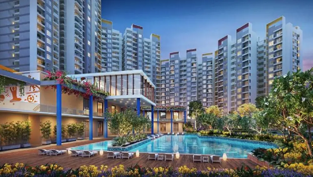 Modern residential complex with multiple high-rise buildings and a swimming pool surrounded by greenery.