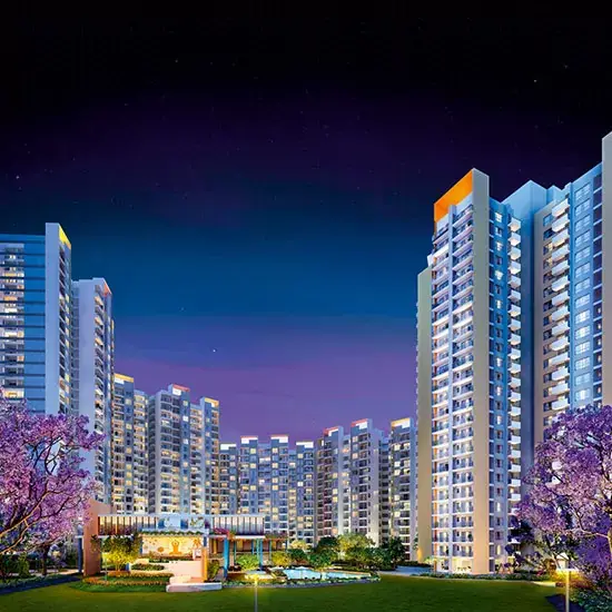 Modern residential buildings illuminated at night with purple flowers in the foreground.