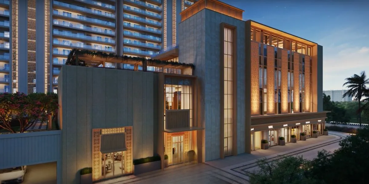 Modern clubhouse with illuminated facade, large windows, and surrounding greenery.