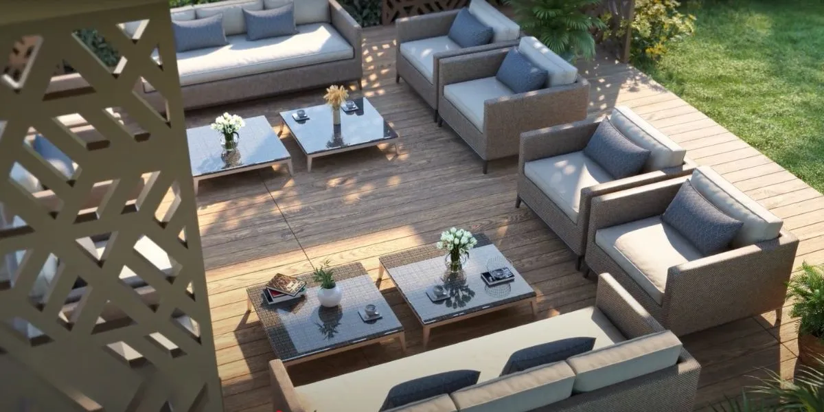 Multiple seating arrangements with cushions, wooden flooring, and decorative plants in a cozy outdoor space.