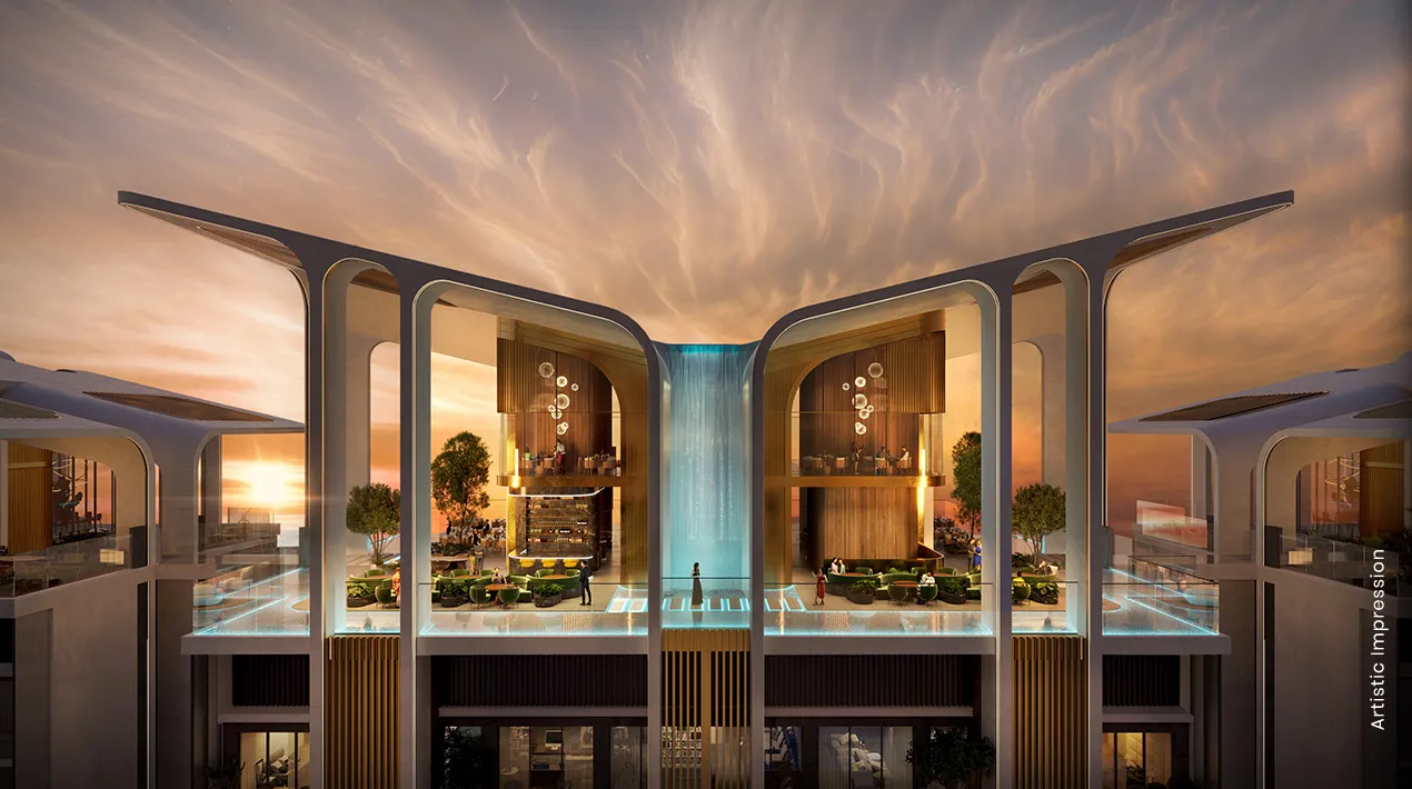 Modern architectural design featuring a waterfall and greenery at sunset.