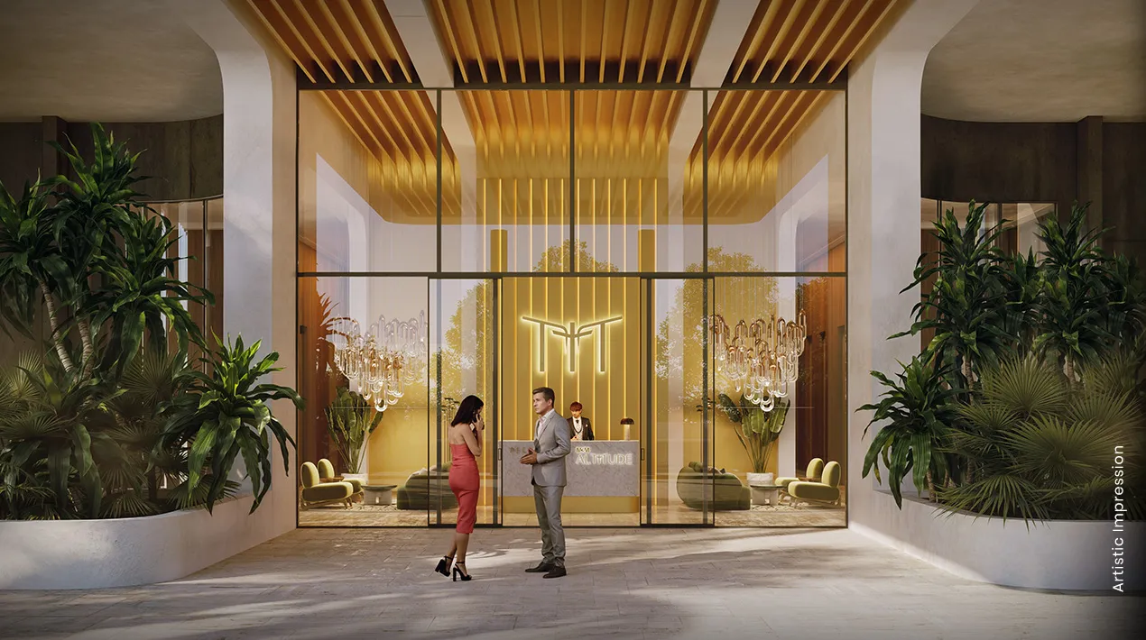 Modern lobby with glass entrance, elegant decor, plants, and two people conversing.