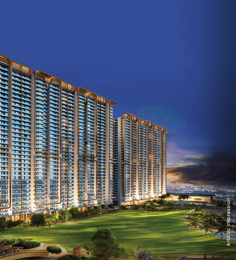 Tall residential buildings with balconies, green lawn, and evening sky in the background.