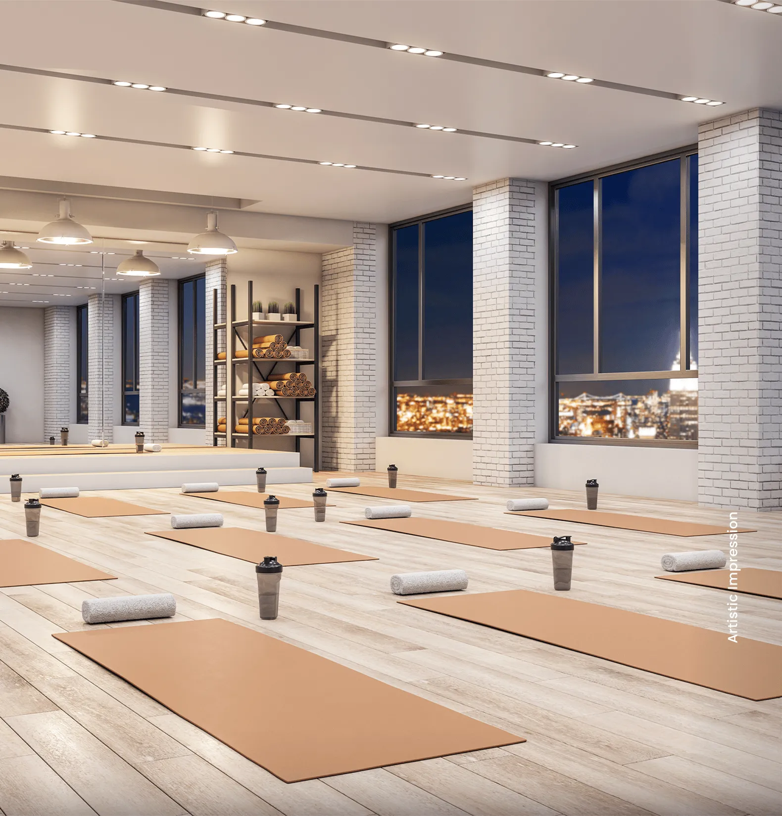 Spacious yoga studio with multiple mats, towels, and water bottles, large windows showcasing city lights.