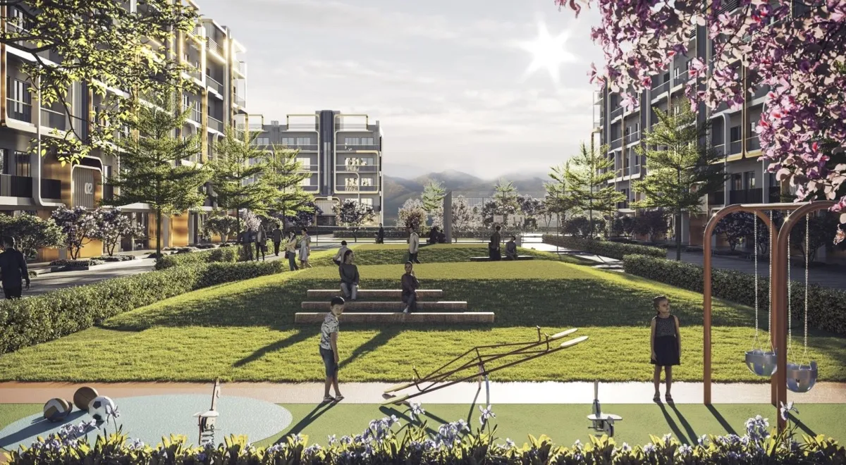 A landscaped park with children playing, benches, and modern apartment buildings in the background.