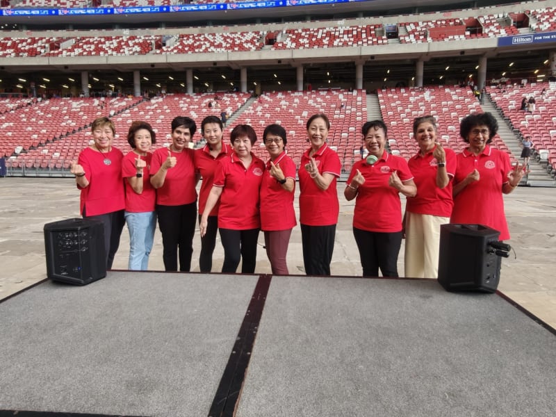 SWA Laughter Yoga volunteers in red polo shirts at the National Stadium