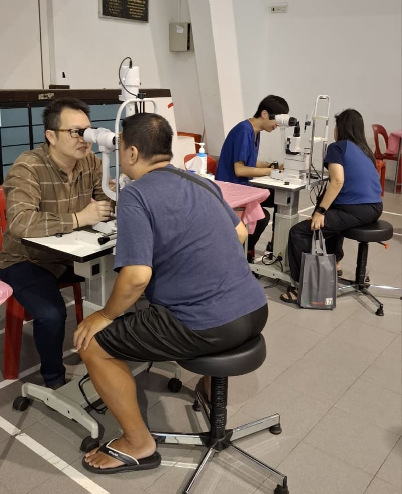 Two doctors conducting slit lamp examinations
