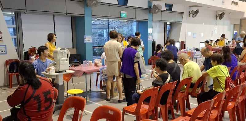Wide view of the busy screening hall with participants