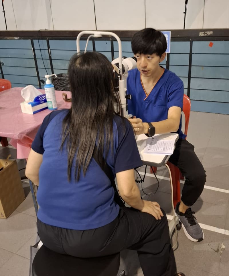 Doctor using slit lamp equipment for eye examination