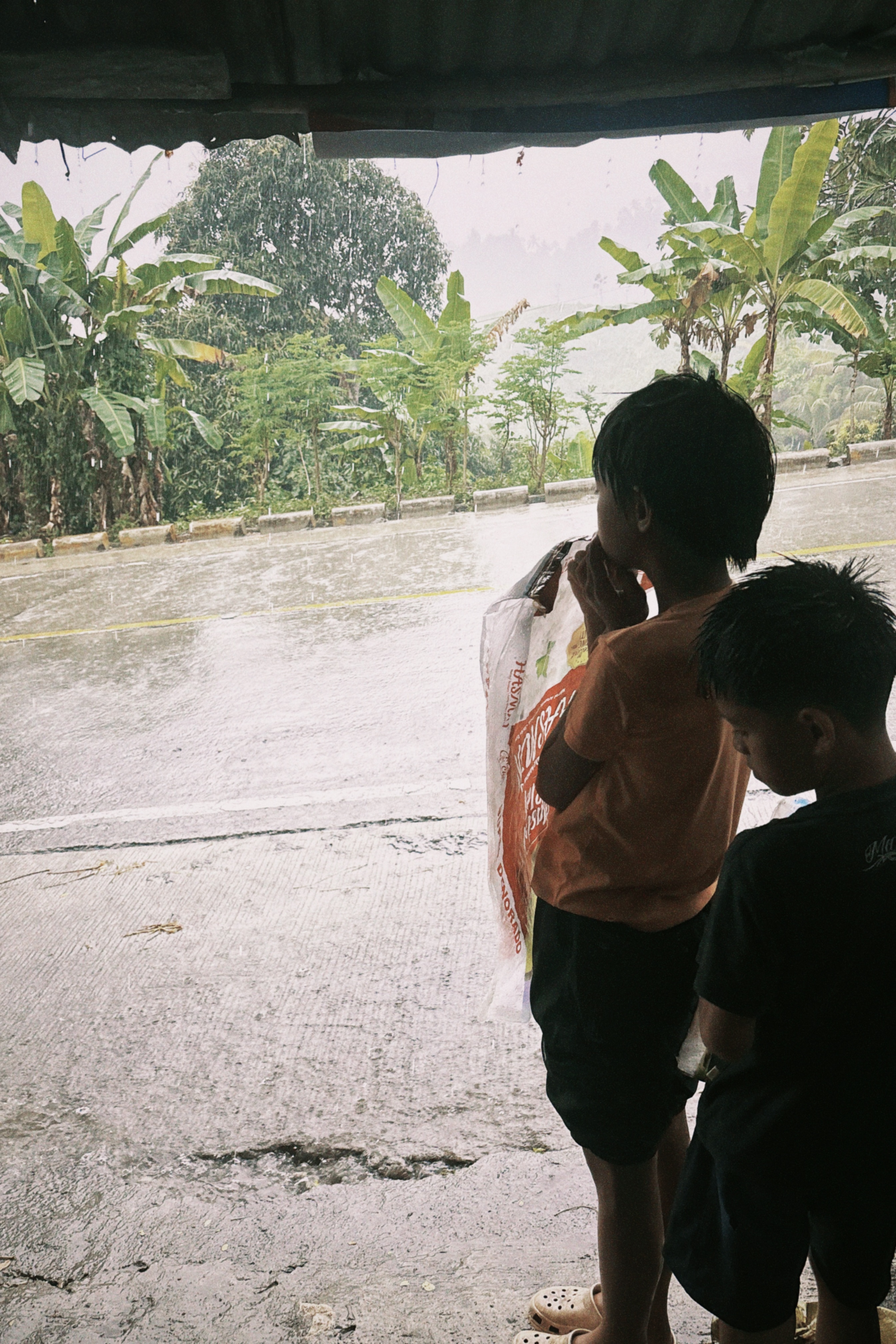 Kids sheltering from the rain together