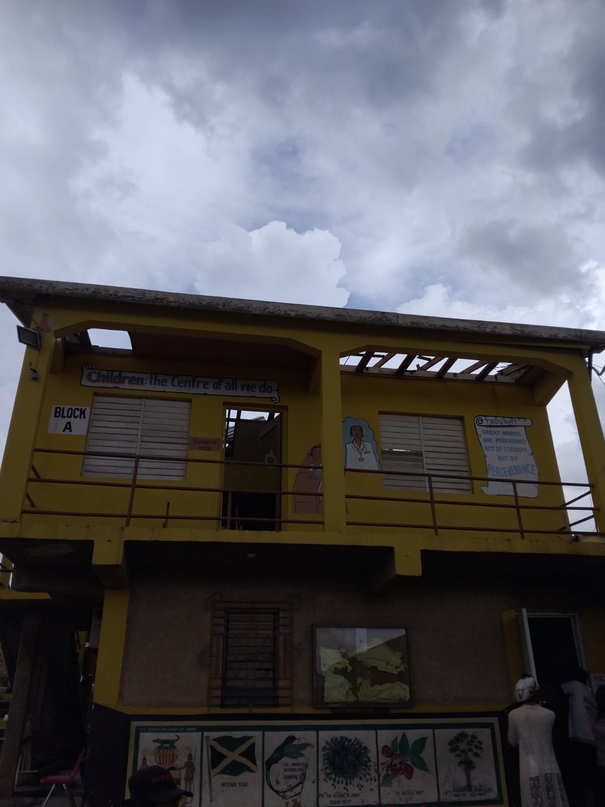Volunteers assessing damaged classroom walls with clipboards
