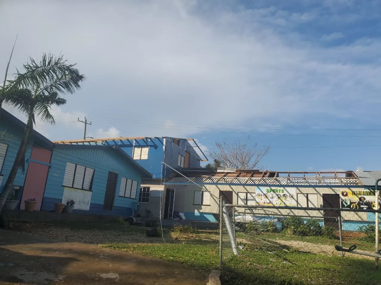 Complete roof destruction and structural damage at Olympus Academy requiring total reconstruction