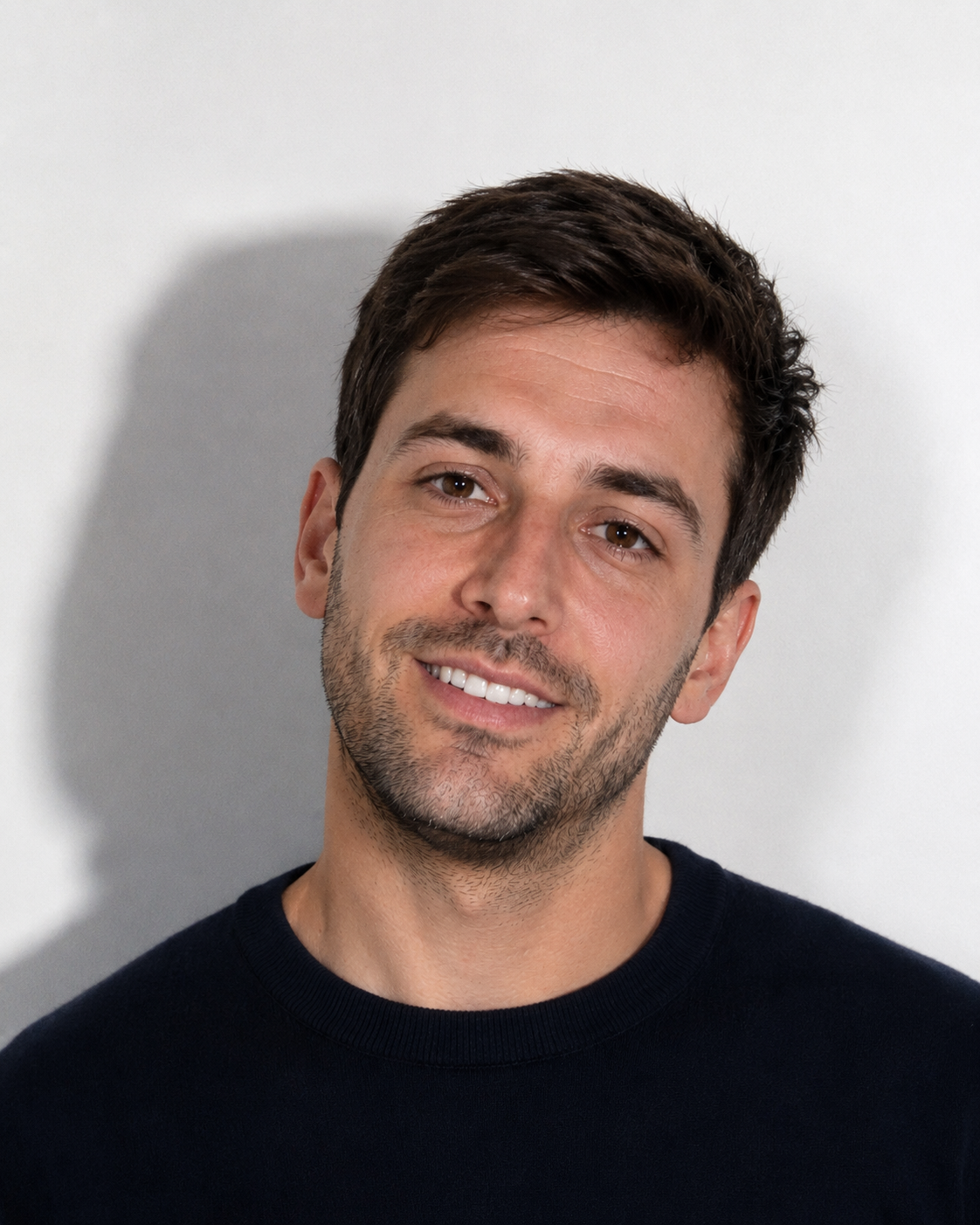 Bad UK passport photo example showing heavy facial shadows and smiling expression