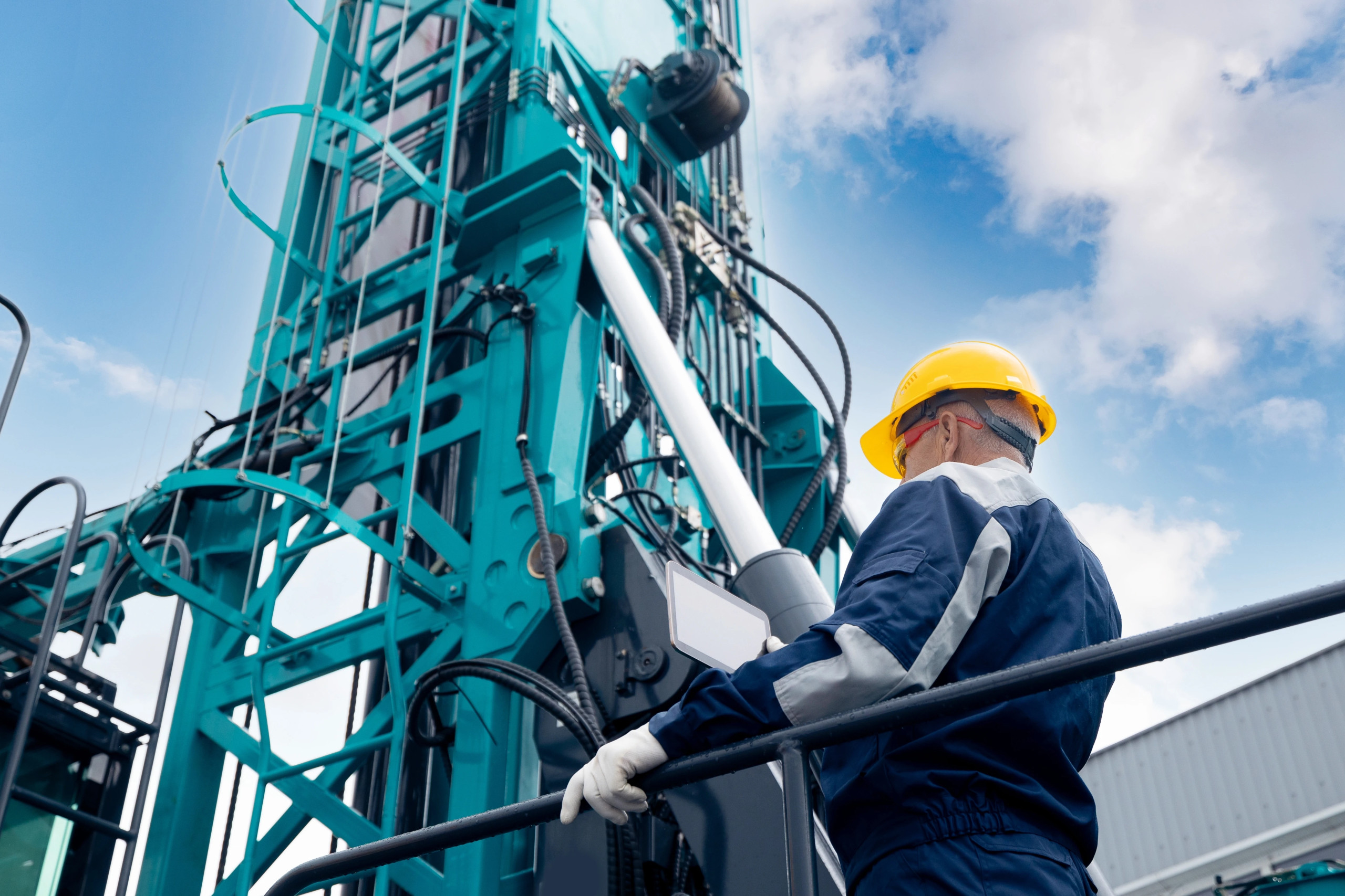 Energy professional reviewing oil and gas production reports on-site