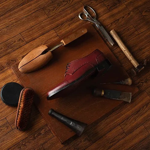 Shoemaking tools and leather on a workbench