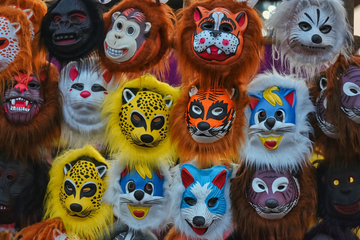 Vibrant animal masks including lions, monkeys, and tigers on display, perfect for festivals.