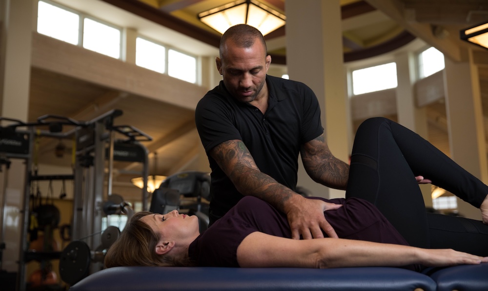 Dominick helping a woman with pain free movement