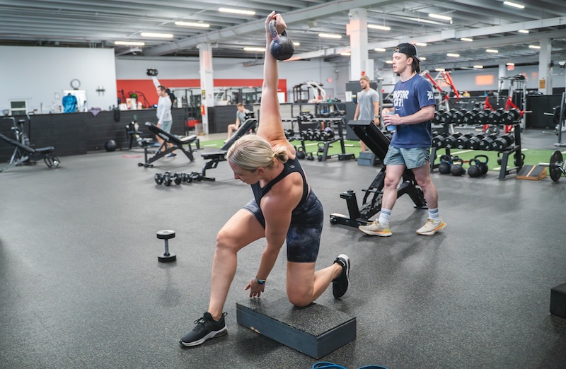 woman holding a kettlebell performing an exercise