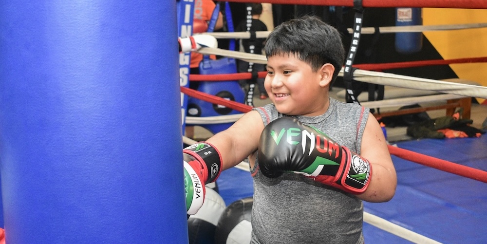 young boy at a boxing class in southpaw gym
