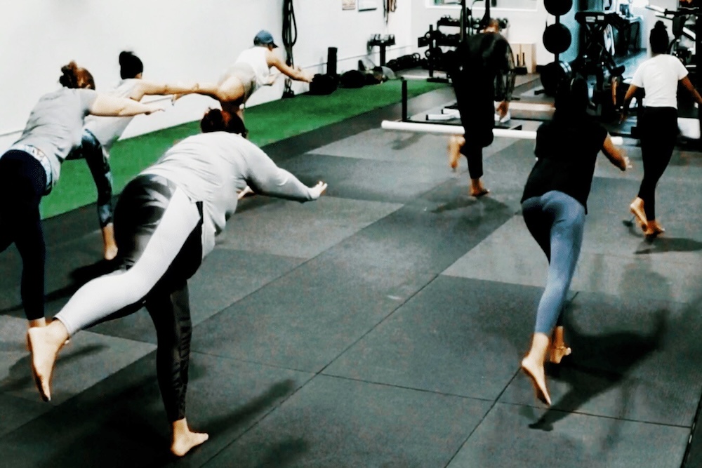 group of people holding a yoga pose