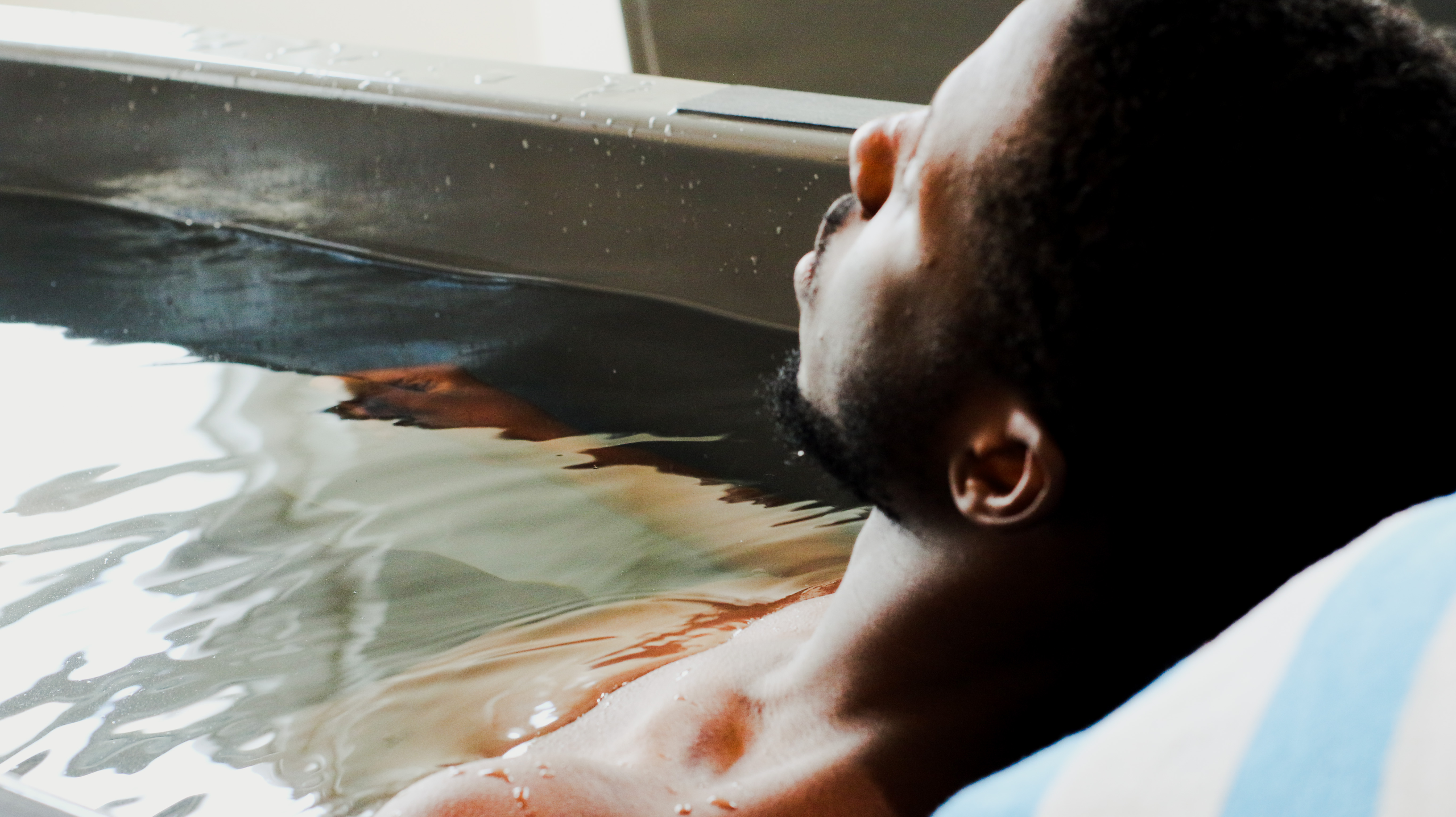 Person stepping into Cold Therapy plunge at The Hot Room