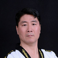 Instructor Grand Master Young Kim with Master Kim's World Taekwondo.