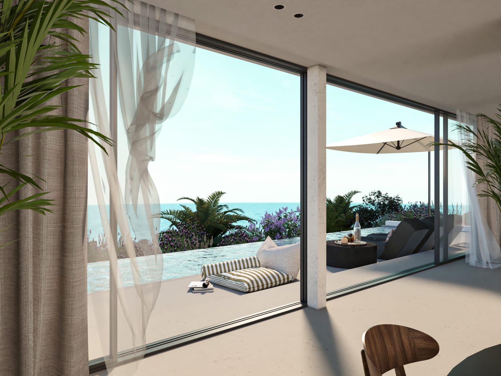 View through sheer curtains to the infinity pool and sea