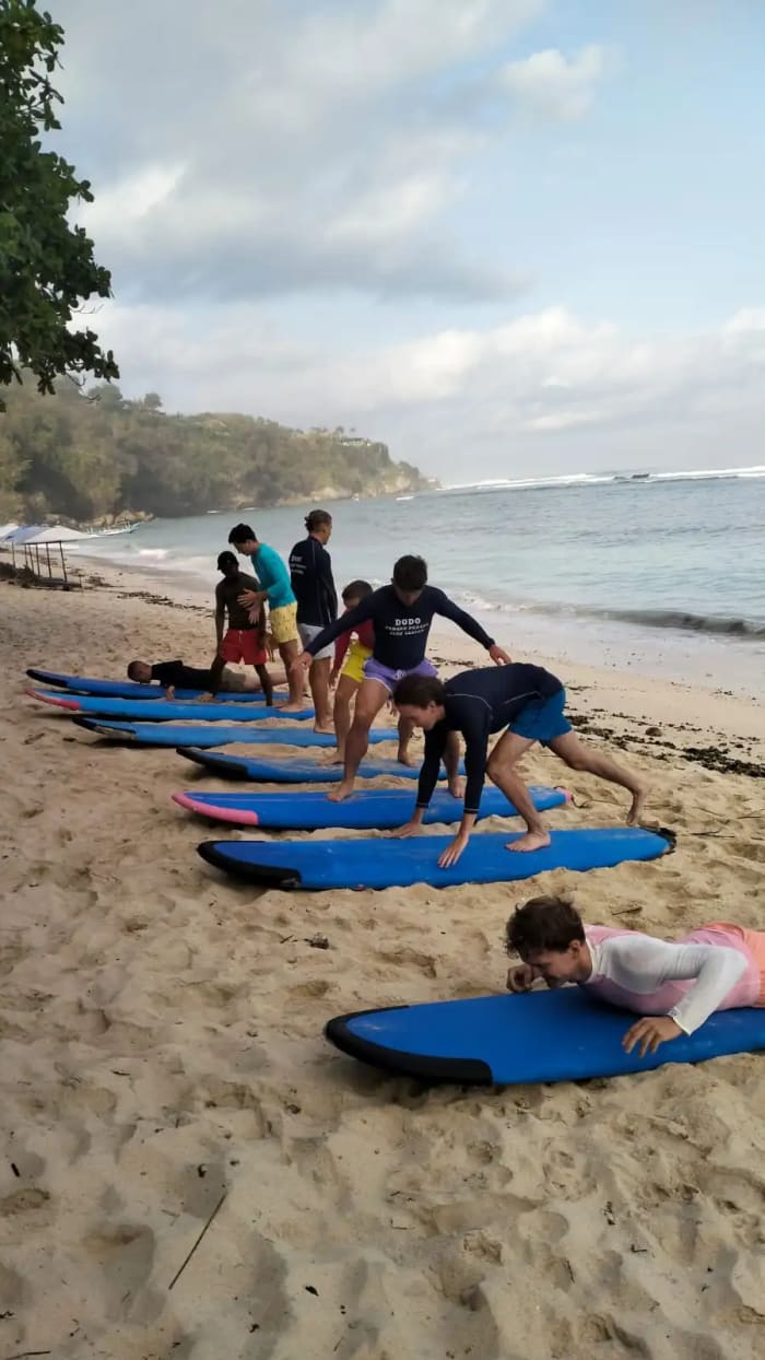 Beginner surfer learning with instructor