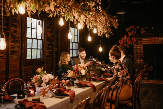 Two couples enjoying dinner with wine at Nobelius Packing Shed