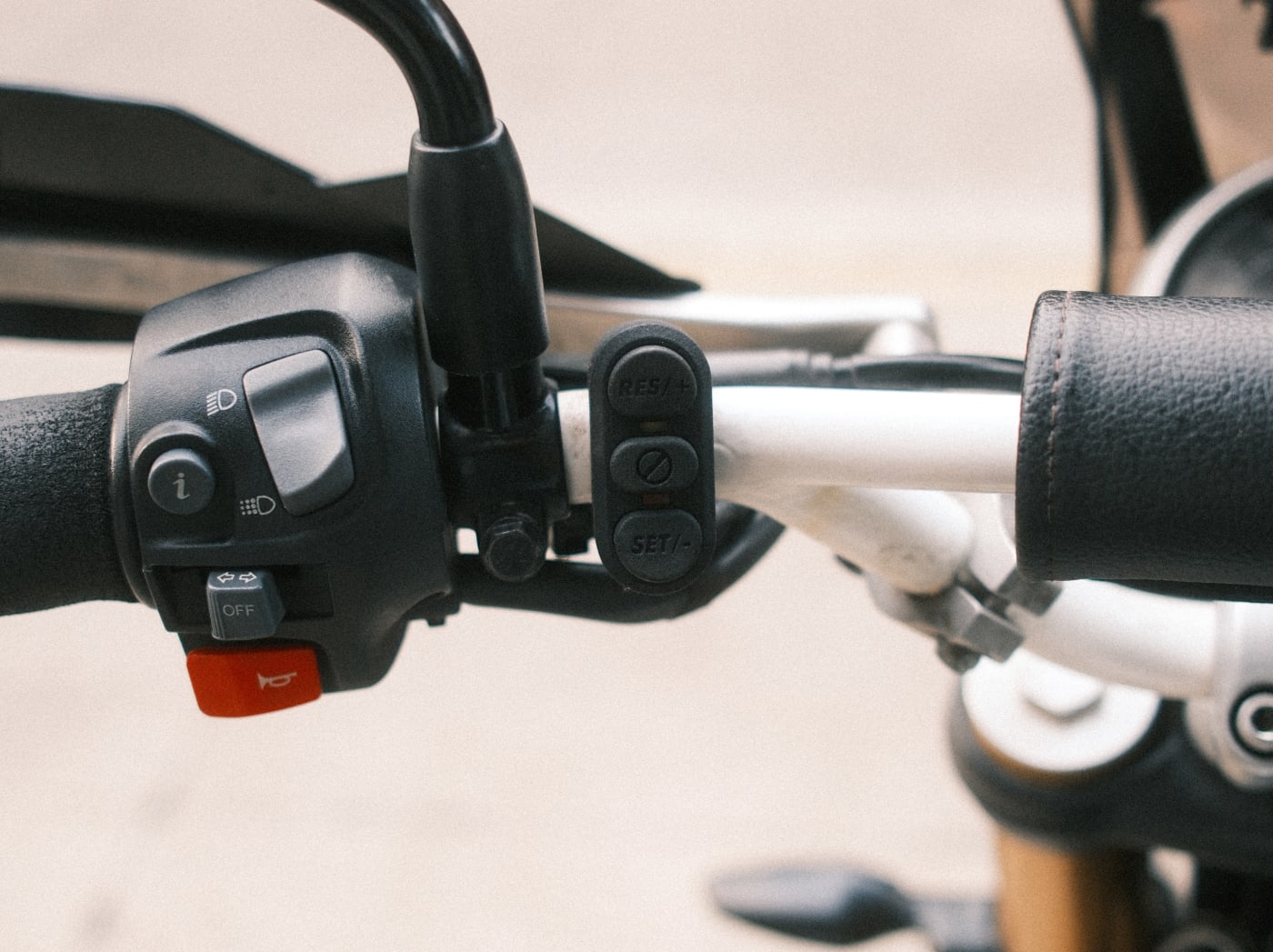 The Bykr cruise control switch pod mounted on the handlebar beside the stock switchgear