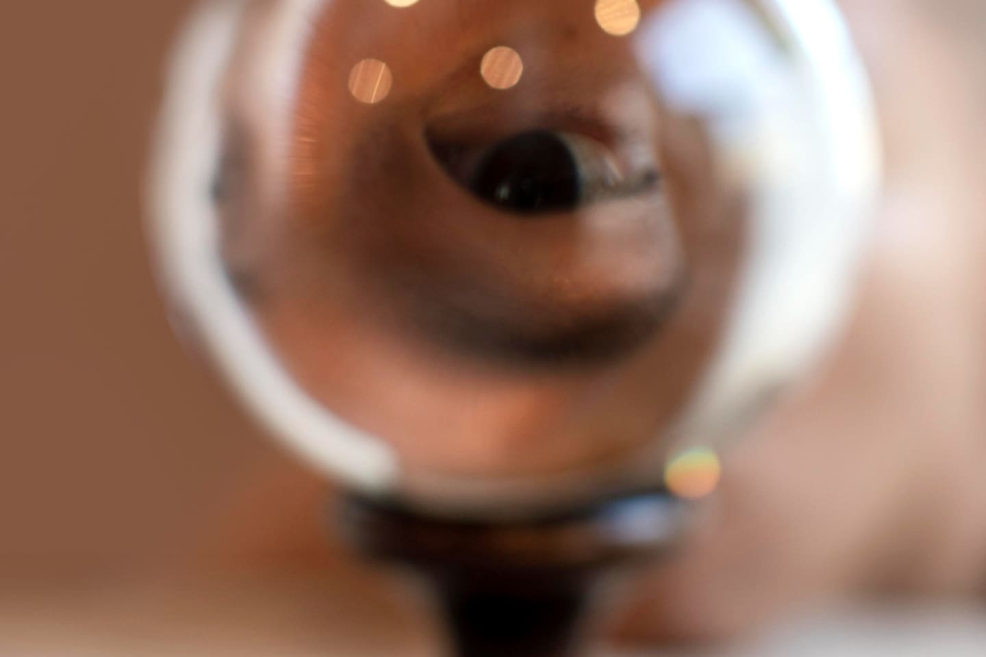 Eye looking throught crystal ball