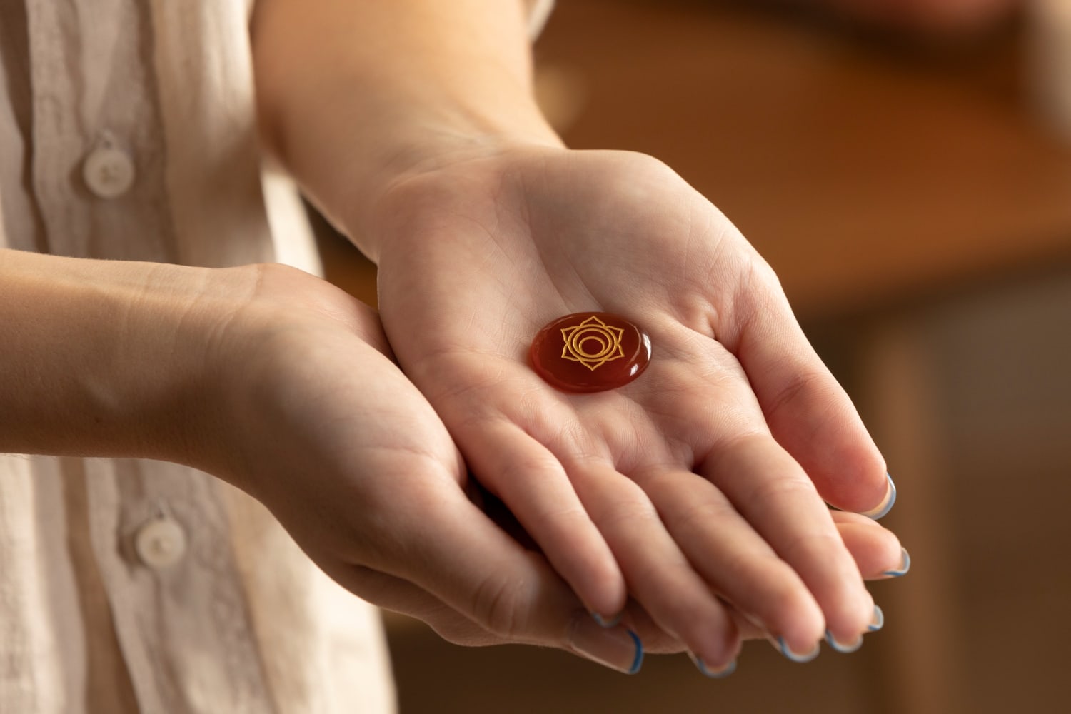 Hands holding carnelian stone 