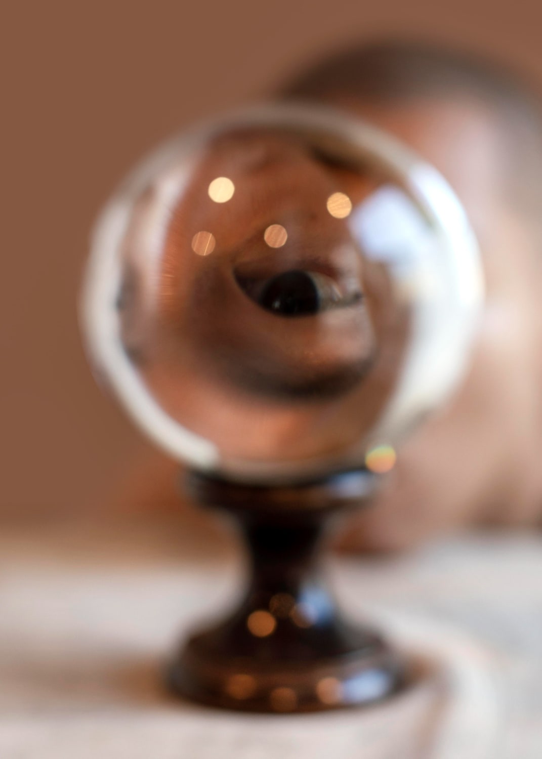 Eye looking throught crystal ball