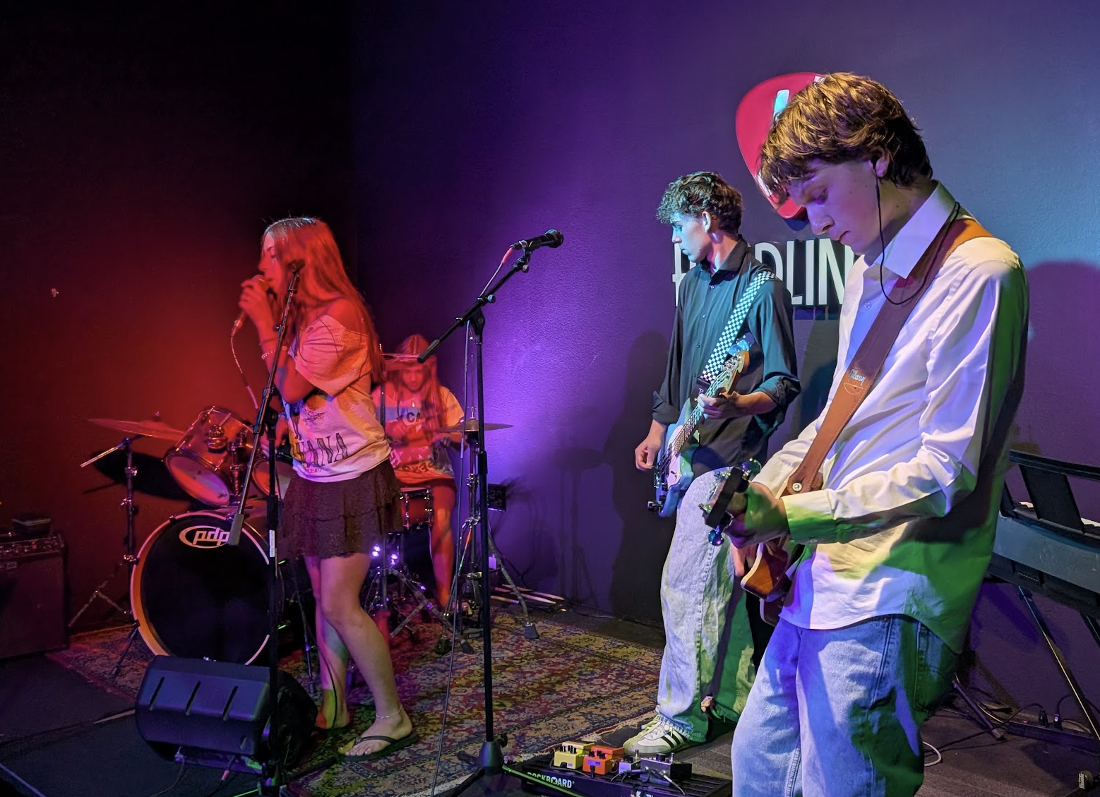 Musicians playing together at Headliner