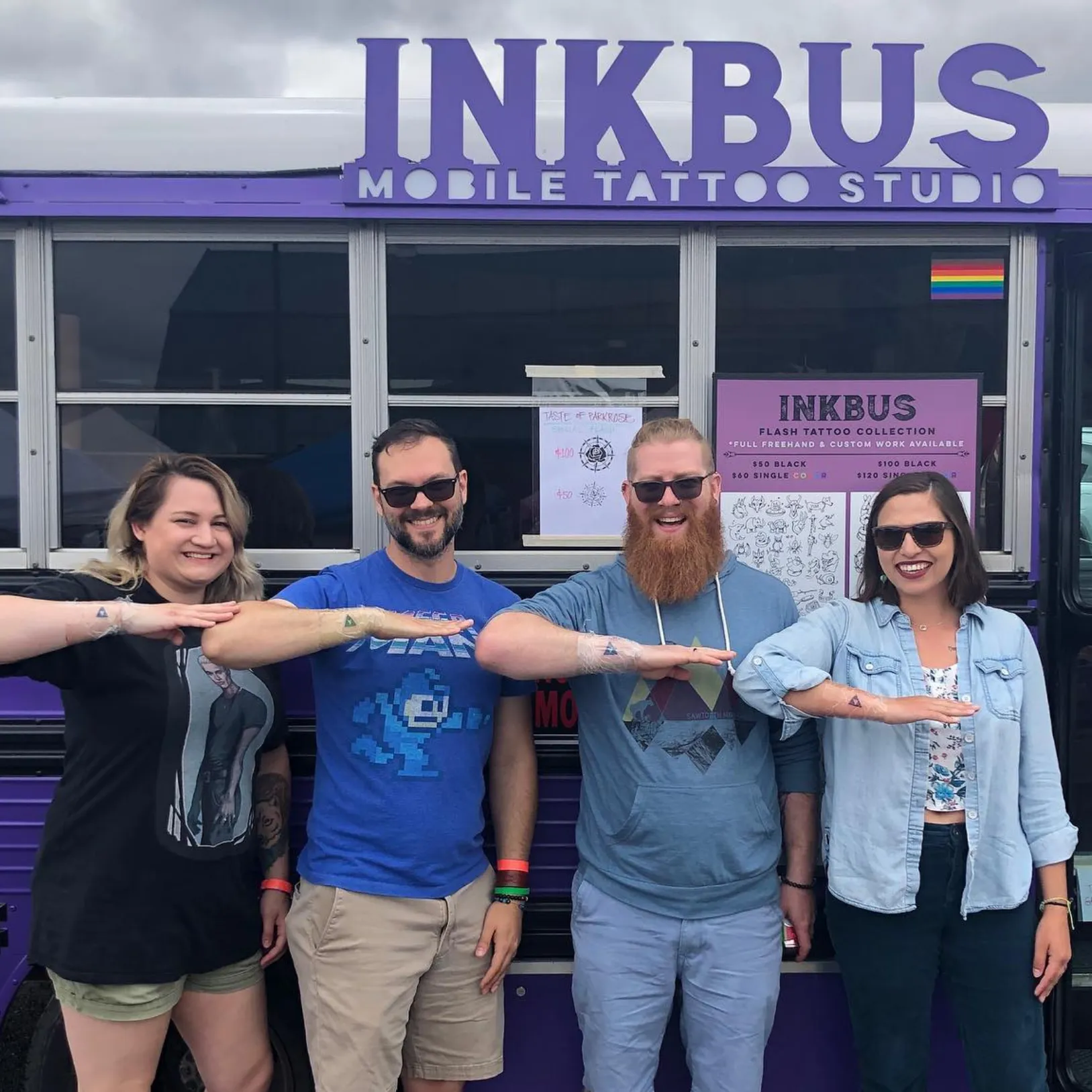 Group of four friend showing off thier new matching tattoos