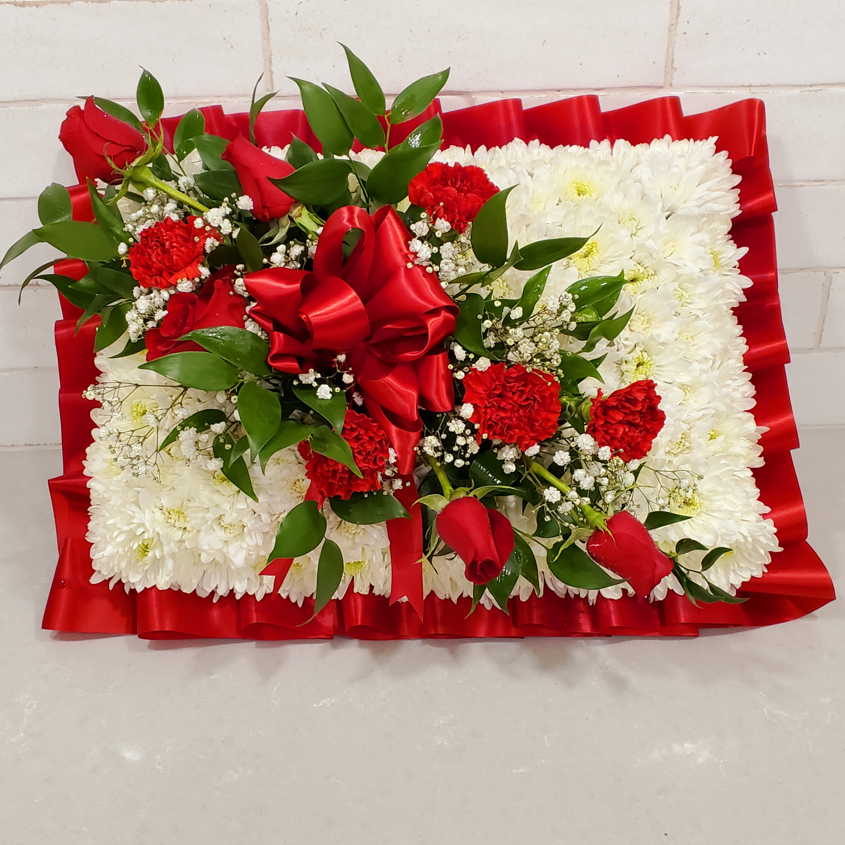 Traditional Pillow Red and White funeral floral tribute by Reynolds Flowers for Shepherd Funeral Home in Carver MA