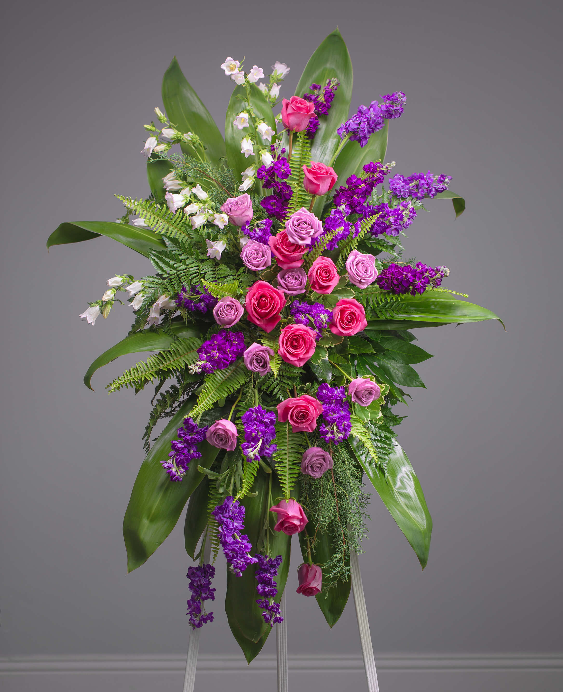 Magenta Reverence Standing Spray | Ivory Florist | Touching