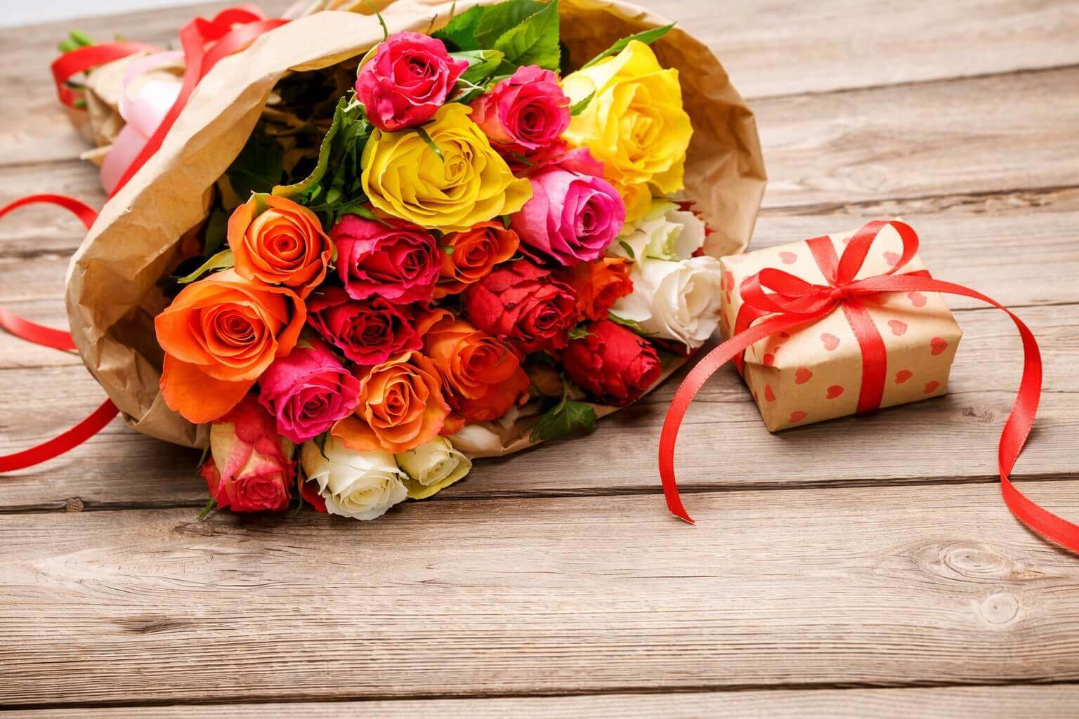 Luxury arrangement of pink and yellow roses representing admiration and friendship