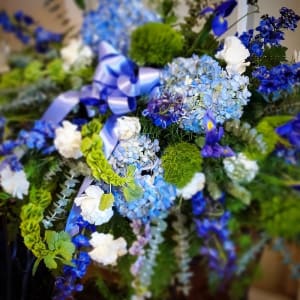 Ocean Casket Cover with Blue Hydrangea and Delphinium Flower Bouquet