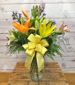 Evolution In Lilies Vased Arrangement Flower Bouquet