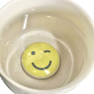 Winky Smile: Floral Surprise in a Fun Mug