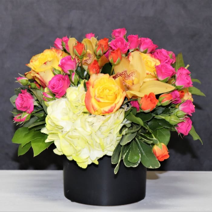 Bright Color Flowers In Any Black Short Vase 